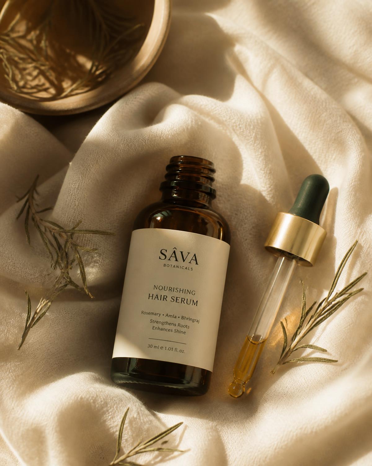 Serum bottle and dropper resting on cream linen with rosemary